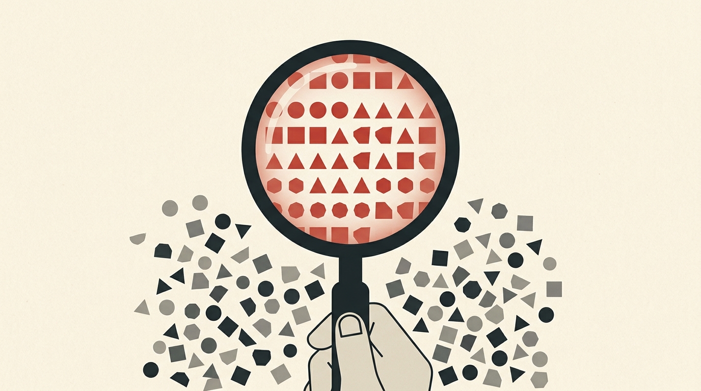 A magnifying glass revealing hidden order in scattered shapes